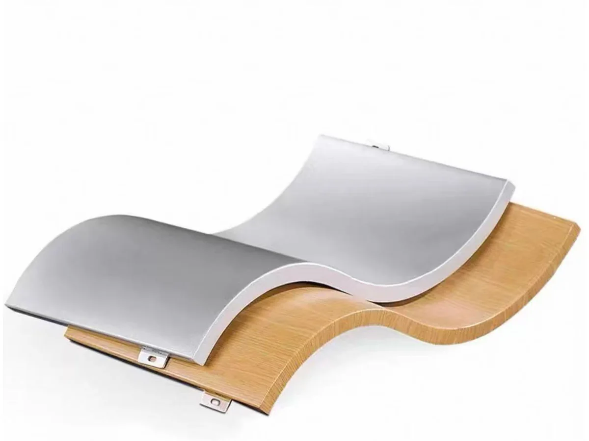 Real silver and wood-grain curved aluminium panel samples showing smooth wave-shaped forming