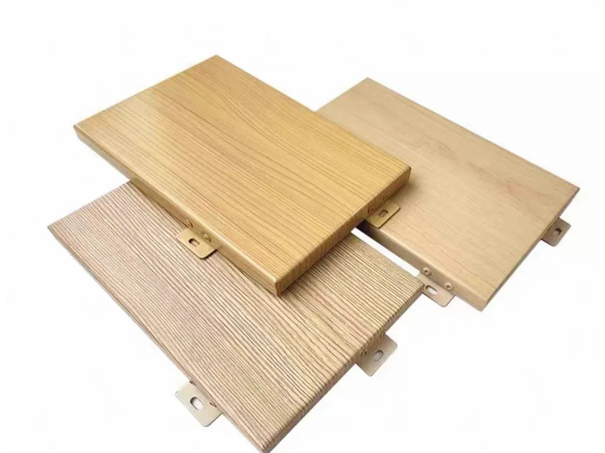 Three real wood-grain aluminium panel samples with different grain tones and fixing tabs